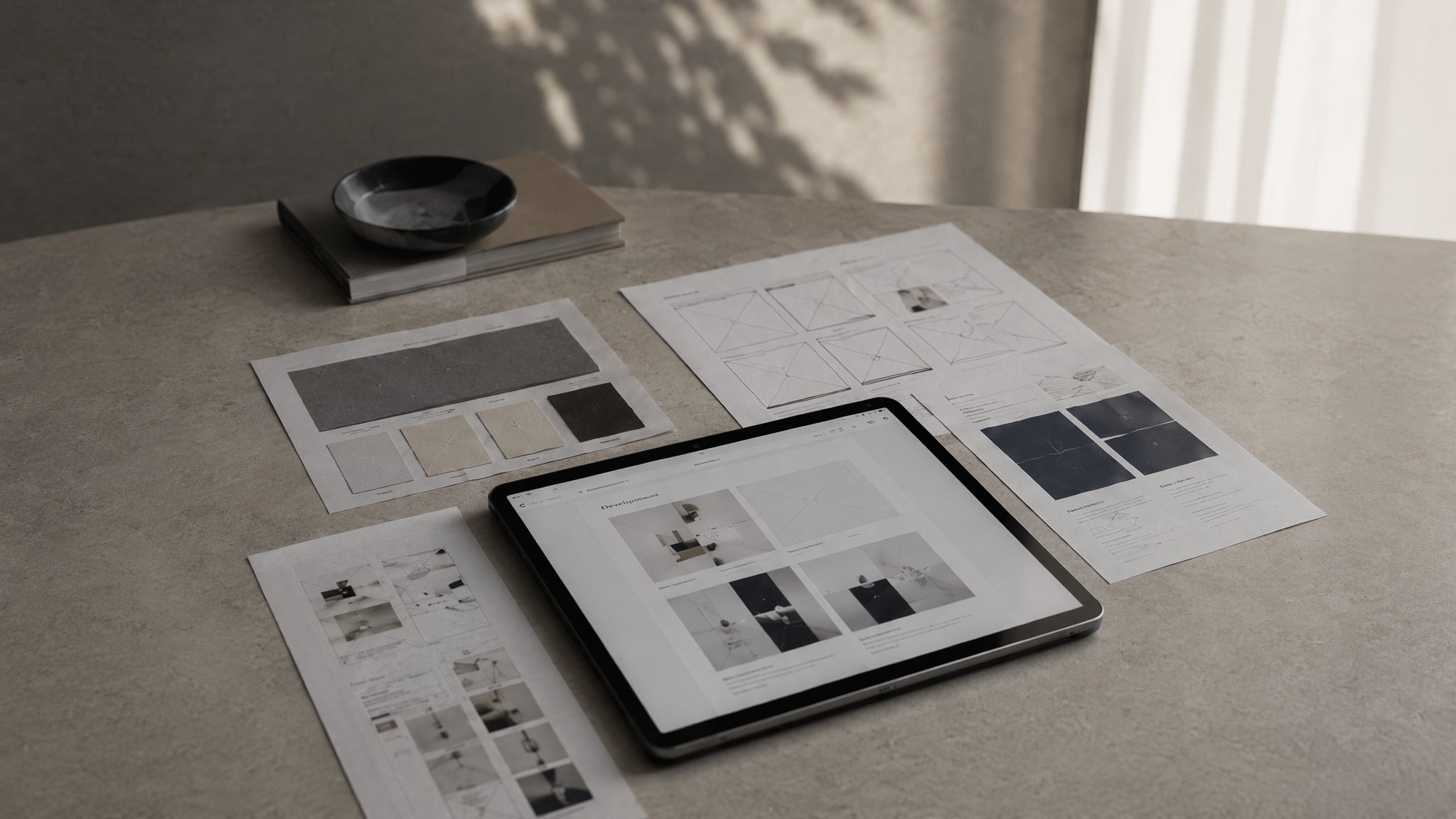 Table with digital tablet displaying design layout on a light surface for advertising marketing website consultant services
